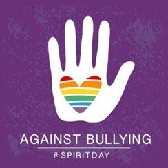 Image shows a hand with a rainbow heart imprinted onto it. The words below read: Against Bullying #SpiritDay