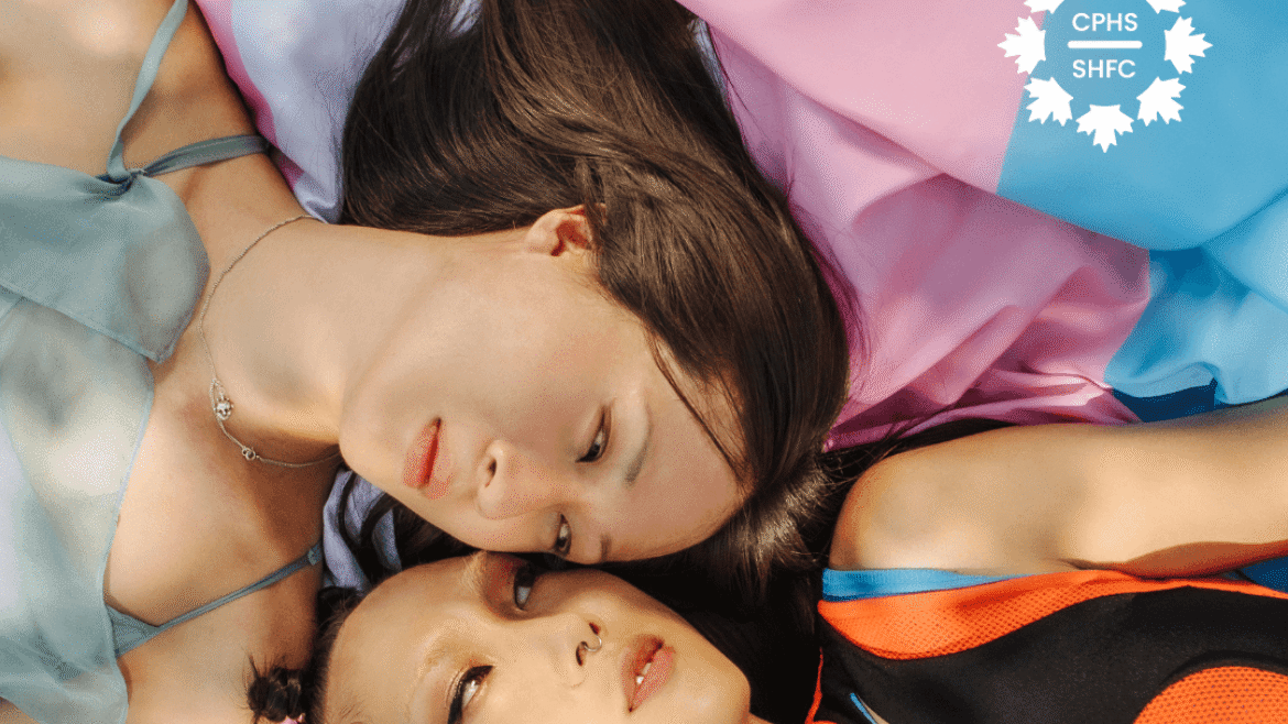 Trans Awareness Month image. The trans flag is seen behind two people lying beside each other.