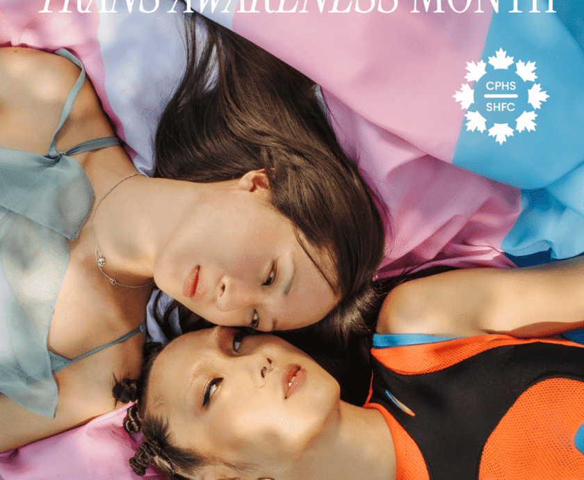 Trans Awareness Month image. The trans flag is seen behind two people lying beside each other.