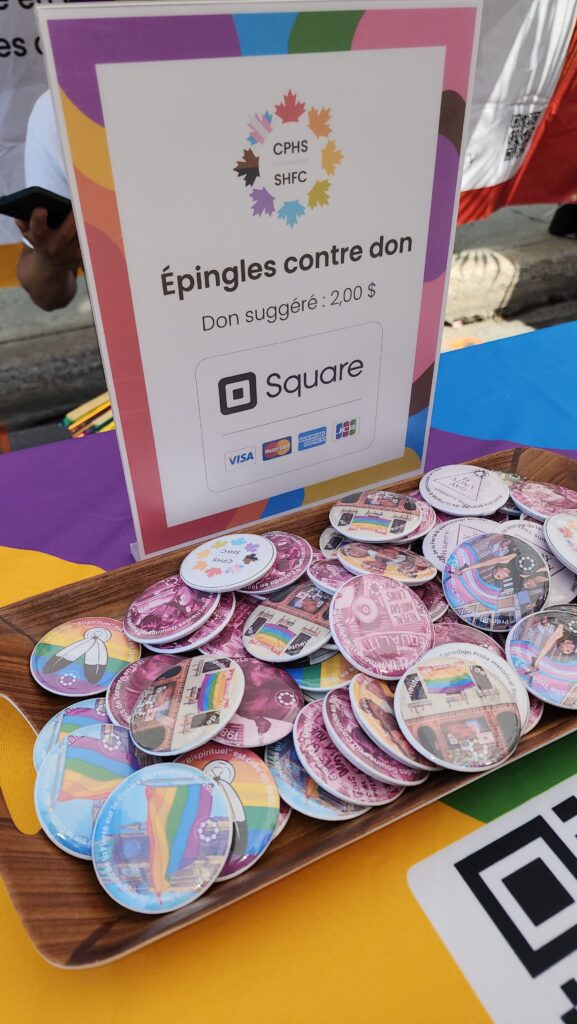 Pins at CPHS' booth at the Montreal Pride Parade.